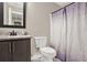 Bathroom featuring a granite-style vanity, framed mirror, neutral walls, and decorative shower curtain at 71 Presley Farm Ln, Rockmart, GA 30153