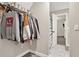 Walk-in closet with hanging clothes, shoe racks, and an entry leading to the ensuite bathroom at 71 Presley Farm Ln, Rockmart, GA 30153