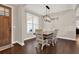 Dining area with a wooden table and white chairs offering a rustic aesthetic at 71 Presley Farm Ln, Rockmart, GA 30153