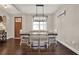 Dining area with dark hardwood floors, wooden table and modern chandelier at 71 Presley Farm Ln, Rockmart, GA 30153