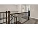 Upstairs hallway with wood railing and spindles and multiple doors leading to bathrooms and bedrooms at 71 Presley Farm Ln, Rockmart, GA 30153