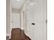 Hallway featuring wood floors, white doors and trim, and neutral wall paint at 71 Presley Farm Ln, Rockmart, GA 30153