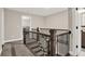 Upstairs hallway with wood railing and spindle and multiple doors leading to bathrooms and bedrooms at 71 Presley Farm Ln, Rockmart, GA 30153