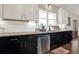 Modern kitchen featuring stainless steel dishwasher, sink, granite countertops, and ample lighting at 71 Presley Farm Ln, Rockmart, GA 30153