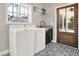 Laundry room featuring decorative tile floor, sink, window, and exterior door at 71 Presley Farm Ln, Rockmart, GA 30153