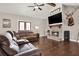 Warm and inviting living room featuring a stone fireplace, hardwood floors, and comfortable seating at 71 Presley Farm Ln, Rockmart, GA 30153