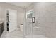 Elegant bathroom showcasing a spacious glass-enclosed shower with marble tile and tiled seat at 71 Presley Farm Ln, Rockmart, GA 30153