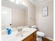 Cozy half-bath featuring wood-look flooring, vanity, and white toilet at 1031 Steeple Run, Lawrenceville, GA 30043