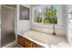 Serene bathroom showcasing a jetted tub, separate shower, and a large window with a view of nature at 1031 Steeple Run, Lawrenceville, GA 30043