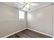 Simple bedroom with a ceiling fan, baseboard trim and a window, ideal for a guest room at 1031 Steeple Run, Lawrenceville, GA 30043