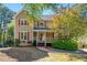 Charming two-story home featuring red shutters and a welcoming front porch at 1031 Steeple Run, Lawrenceville, GA 30043