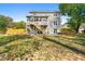 Two-story home with a spacious backyard, featuring a deck, patio, and well-maintained lawn at 1031 Steeple Run, Lawrenceville, GA 30043