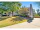 View of the home with a spacious yard and driveway and a partial brick wall at 1031 Steeple Run, Lawrenceville, GA 30043