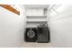 Functional laundry room with a washer, dryer, storage shelves, and hooks for hanging at 1031 Steeple Run, Lawrenceville, GA 30043