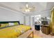 Comfortable main bedroom featuring a tray ceiling, ceiling fan, and an attached office space at 1031 Steeple Run, Lawrenceville, GA 30043