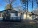 This backyard features a modern home with a wooden deck and black trim at 1055 Pinecrest Dr, Forest Park, GA 30297