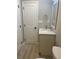 Compact bathroom featuring a vanity with sink, mirror, and nearby toilet, maximizing space and functionality at 1055 Pinecrest Dr, Forest Park, GA 30297