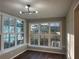 The eating area has hardwood floors, a modern light fixture, many windows and white trim at 1055 Pinecrest Dr, Forest Park, GA 30297