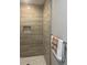 This tiled shower features built-in shelving and a modern shower head at 1055 Pinecrest Dr, Forest Park, GA 30297