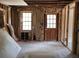 Interior view of a room with exposed framing, a wooden door, and two windows at 5325 Victory Blvd, Morrow, GA 30260