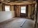 Living room under construction featuring exposed framing and hardwood flooring at 5325 Victory Blvd, Morrow, GA 30260