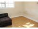 Bedroom featuring a large window, providing ample natural light, and laminate wood flooring at 6441 Holiday Blvd, Forest Park, GA 30297