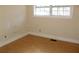 Bedroom featuring a large window, providing ample natural light, and laminate wood flooring at 6441 Holiday Blvd, Forest Park, GA 30297