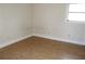 Cozy bedroom with laminate flooring, bright window, and neutral wall color at 6441 Holiday Blvd, Forest Park, GA 30297