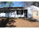 Charming single-story home with a painted white brick and dark shutters, offering timeless curb appeal at 6441 Holiday Blvd, Forest Park, GA 30297