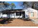 Charming single-story home with a painted white brick and dark shutters, offering timeless curb appeal at 6441 Holiday Blvd, Forest Park, GA 30297