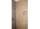 Modern shower featuring sleek wood-look tiling and a convenient recessed niche at 6441 Holiday Blvd, Forest Park, GA 30297