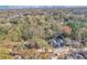 Expansive aerial view shows the home nestled in a lush, green neighborhood near the city skyline at 676 S Grand Nw Ave, Atlanta, GA 30318