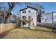 A modern two-story home with a spacious backyard featuring a wooden deck with stairs at 676 S Grand Nw Ave, Atlanta, GA 30318