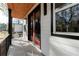 Balcony featuring a dark metal railing, red framed sliding door and a light grey tile floor at 676 S Grand Nw Ave, Atlanta, GA 30318