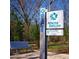 Informative Atlanta BeltLine sign with trail information amidst a picturesque park setting, complemented by a blue park bench at 676 S Grand Nw Ave, Atlanta, GA 30318