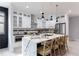 Bright kitchen featuring white cabinets, granite countertops, and a large island with seating at 676 S Grand Nw Ave, Atlanta, GA 30318