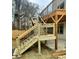 Exterior wooden stairs with black metal railings lead to the deck of this modern home at 676 S Grand Nw Ave, Atlanta, GA 30318