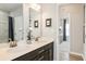 Bright bathroom featuring double vanity with quartz counters and access to bedroom and shower at 1141 Burlington Ct, Mcdonough, GA 30253