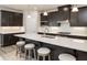 Bright kitchen features a large island with seating, modern appliances, and stylish dark brown cabinetry at 1141 Burlington Ct, Mcdonough, GA 30253