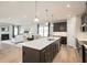 Open-concept kitchen with stainless steel appliances and adjacent living room at 1141 Burlington Ct, Mcdonough, GA 30253