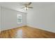 Bright bedroom featuring hardwood floors, ceiling fan, and a window at 1256 Ridgecrest Se Ln, Smyrna, GA 30080