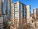 Luxury condo building with balconies, many windows and mature trees at 275 13Th Ne St # 402, Atlanta, GA 30309