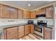 Kitchen with wood cabinets, dark countertops, and stainless steel oven at 711 Providence Dr, Lawrenceville, GA 30044