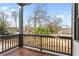 Outdoor covered patio with wooded back yard views and grey wooden railings at 965 Boulevard Se # A, Atlanta, GA 30312