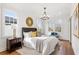 Bright bedroom with hardwood floors, a tufted headboard, and multiple windows for natural light at 965 Boulevard Se # A, Atlanta, GA 30312