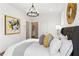 Bedroom featuring white bedding with grey accents, artwork and a stylish chandelier at 965 Boulevard Se # A, Atlanta, GA 30312