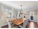 Elegant dining area with a large wood table, seating for eight, and natural light at 3185 Birchfield Trce, Marietta, GA 30068