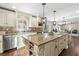 Kitchen island with seating, stainless steel dishwasher, and granite countertops at 3185 Birchfield Trce, Marietta, GA 30068