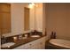 Bathroom featuring a soaking tub with tile surround, a dual sink vanity, and neutral colors at 4666 Magnolia Commons, Dunwoody, GA 30338