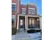 Charming brick townhouse featuring black-framed windows and a welcoming front porch with columns at 4666 Magnolia Commons, Dunwoody, GA 30338